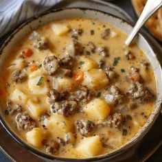 a bowl of soup with meat and potatoes