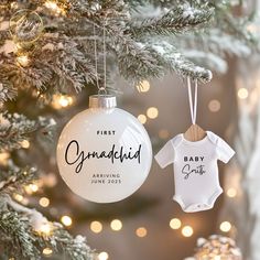 a baby's first christmas ornament hanging from a tree