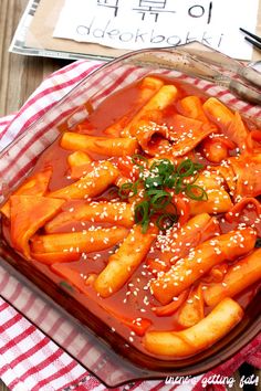 a glass dish filled with carrots covered in sauce