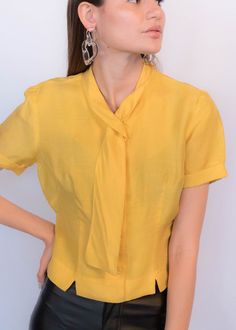 Vintage Silk Short Sleeve Blouse, Vintage Silk Blouse With Short Sleeves, Semi-formal Tie Neck Fitted Blouse, Semi-formal Fitted Tie Neck Blouse, Vintage Silk Collared Top, Vintage Solid Color Blouse For Daywear, Elegant Yellow Formal Tops, Vintage Fitted Tops For Semi-formal Occasions, Fitted Vintage Tops For Semi-formal Occasions