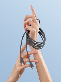 two hands are holding an extension cord in the air