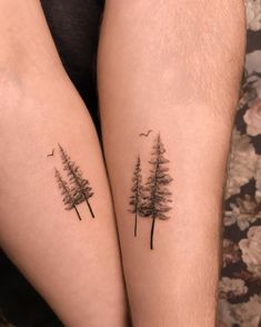 two people with tattoos on their legs, one has trees and the other has birds