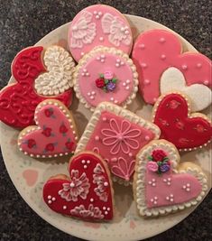 heart shaped cookies are arranged on a plate