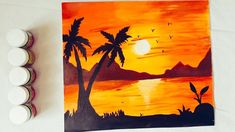 an orange sunset with palm trees and birds painted on it, next to some paint rollers