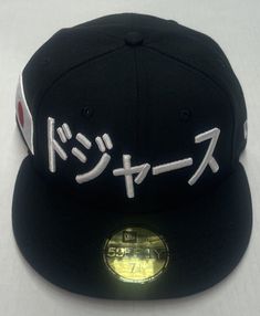 Show your love for the LA Dodgers and Japan with this unique New Era 59FIFTY fitted hat featuring a side patch with Japanese writing and a flag theme. Made of polyester with a black color, this hat is perfect for casual occasions during the summer season. The hat size is 7 1/8 and the brand is New Era, known for their quality hats and attention to detail. It is a great addition to any men's accessories collection and a must-have for LA Dodgers fans.