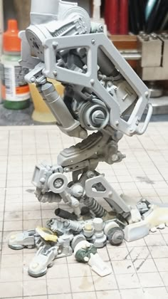 a robot made out of metal parts on the ground