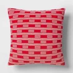 a red and white pillow with lines on it