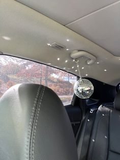 a disco ball hanging from the ceiling in a car