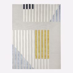 a white rug with blue, yellow and grey stripes on the bottom half of it