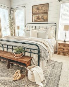 a bed room with a neatly made bed and a wooden bench next to the bed