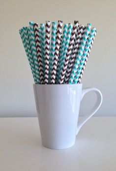 several black and white striped paper straws in a cup