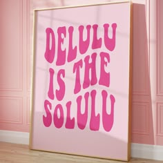 a pink poster with the words delu is the soul on it in front of a pink wall