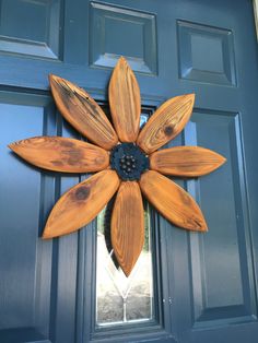 a wooden flower on the front door of a house