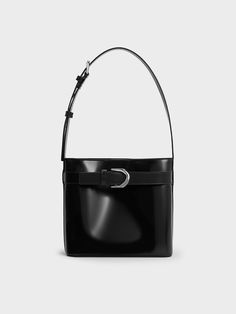 The Gabine collection is expanded with a brand new silhouette -- a sleek and slouchy bucket style. Made with black calf leather, this bag promises excellent style mileage and versatility. It will complement a wide range of styles, from casual to edgy. Fitted with a magnetic closure, it also offers easy access to your belongings. The thick shoulder strap ensures carrying comfort, and can be easily adjusted to your preferred length. Cheap Black Square Bucket Bag, Black Leather Bucket Bags, Luxury Black Pebbled Leather Bucket Bag, Modern Leather Bucket Bag For Evening, Modern Bucket Shoulder Bag With Silver-tone Hardware, Elegant Hobo Bag With Gunmetal Hardware For Evening, Modern Leather Bucket Bag For Business, Modern Leather Business Bucket Bag, Modern Shopping Bucket Bag With Silver-tone Hardware