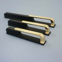 two black and gold bookends sitting on top of a table