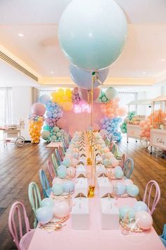 a table set up for a party with balloons