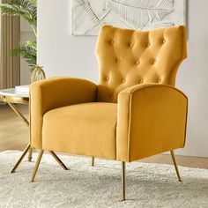 a yellow chair sitting on top of a white rug