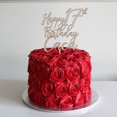 a red cake with white frosting and a happy 7th birthday candle