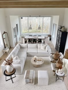 a living room filled with lots of white furniture