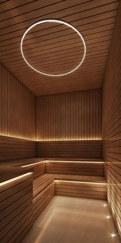 an empty sauna with wooden walls and lighting