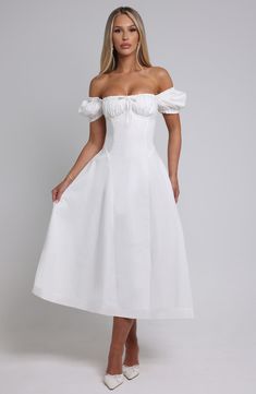 The dreamy Elora dress is ultra feminine, made in our premium non-stretch cotton blend fabric that feels as good as it looks. With a super cinched waist, the puff sleeves and bust are gathered with a tie detail for a super pretty finish. The midi skirt is complete with a dropped waist silhouette. Style it up with an effortless knot and heeled mules. 



Colour: Ivory.

Premium non-stretch cotton blend fabric.

Elasticated puff sleeves which can be worn on or off the shoulder.

Ruched, gathered c Homecoming Dresses Corset, White Dress Spring, Midi Dress Wedding Guest, Dresses Flowy, Split Long Dress, Ultra Feminine, Maxi Dress Sale, Cotton Blend Fabric, Sparkle Dress