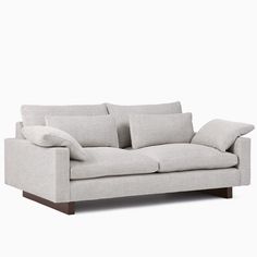 a white couch with pillows on top of it