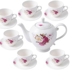 a white tea set with pink roses on it