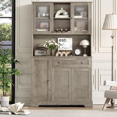 a living room scene with focus on the china cabinet