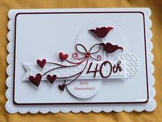 a white card with red hearts on it and the words forty or forty anniversary written in cursive writing