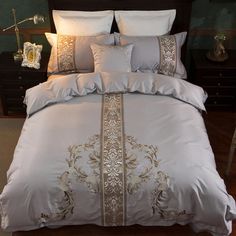 a bed with white and gold comforters in a room