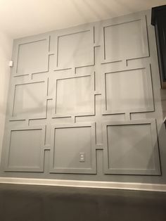 the wall is painted white and has many squares on it