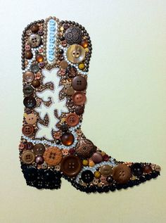 a cowboy boot made out of buttons and other things on the wall in front of a white wall