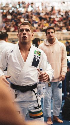 a man standing in front of a crowd holding a water bottle