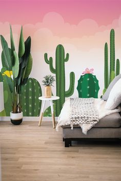 a living room with cactus wallpaper in the background and a couch next to it