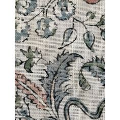 a close up view of an embroidered fabric with flowers and leaves on it's side