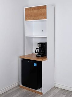 a small white shelf with a black coffee maker on it and a wooden counter top