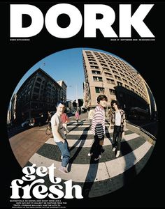 the cover of dork magazine featuring three young men walking across a crosswalk with buildings in the background