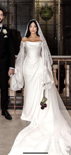 a man and woman dressed in wedding attire