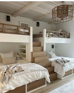 two beds in a room with wooden stairs