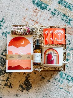 an open box with some items in it on a carpeted floor next to a cup