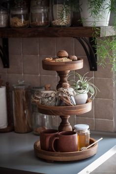 three tiered tray with plants and spices on it