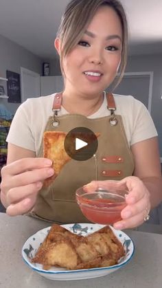 a woman holding a plate with food on it in front of her and the video is showing