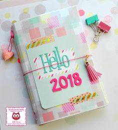 an open planner book with the words hello 2018 on it and some decorations around it