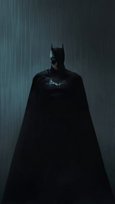 a batman standing in the rain with his cape open and eyes closed, wearing a black suit