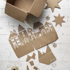 cardboard cut out houses and stars on the floor