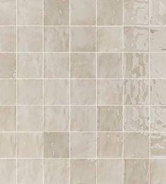 a tile wall with white and gray colors