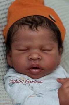 a newborn baby wearing an orange hat