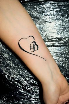 a person with a heart tattoo on their arm