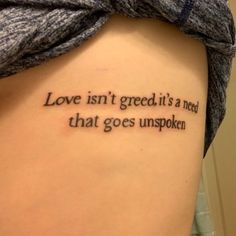 a woman with a tattoo saying love isn't greed it's a need that goes unspoken