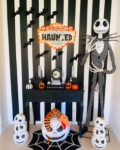 a room decorated for halloween with black and white striped walls